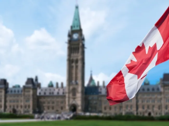 canada flag and government building